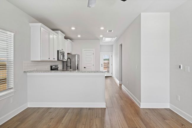 The well-appointed kitchen is the hub for family meals and socializing. The breakfast bar is a natural gathering spot providing a place to catch up as dinner is being prepared. | Image 5