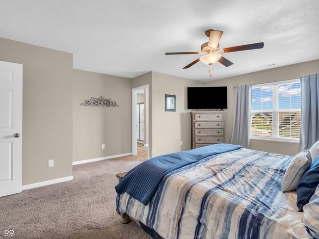 carpeted bedroom with a ceiling fan and baseboards | Image 26