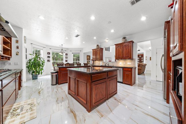 Open kitchen with an island and large windows | Image 10