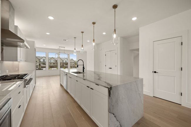 Situated between the dining room and family room, this over the top kitchen is an entertainers dream! | Image 11
