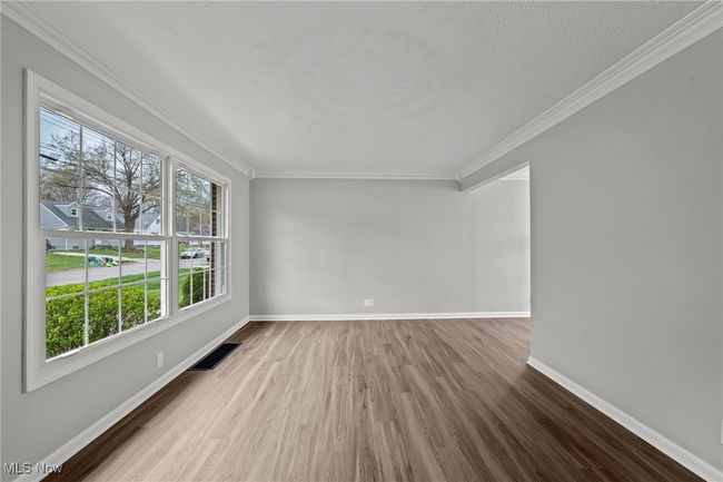Empty room featuring baseboards, wood finished floors, and ornamental molding | Image 10