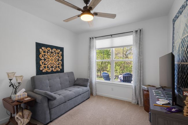 Carpeted living room featuring baseboards and a ceiling fan | Image 19