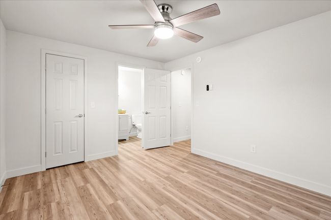 Unfurnished bedroom featuring light wood-style flooring and a ceiling fan | Image 14