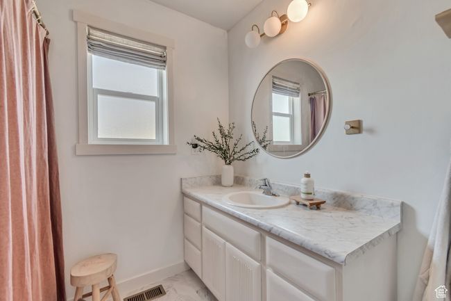 Full bathroom featuring marble finish flooring, vanity, and a shower with shower curtain | Image 16