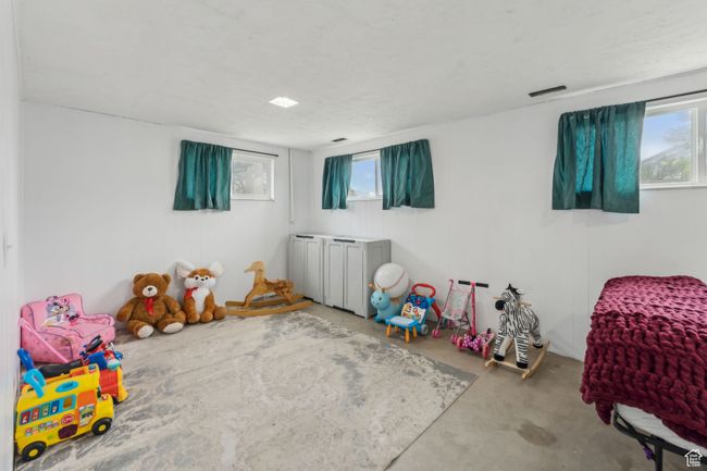 Recreation room featuring concrete flooring, plenty of natural light, and visible vents | Image 21