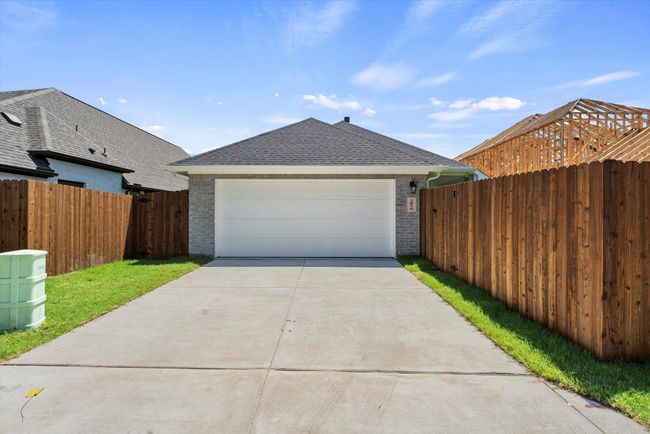 View of front of house featuring brick siding, a shingled roof, and driveway | Image 23