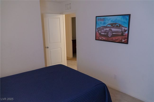 Carpeted bedroom featuring baseboards and visible vents | Image 51