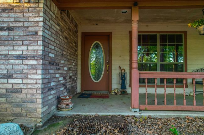 Property entrance featuring covered porch and brick siding | Image 6