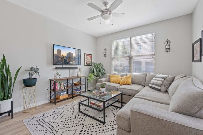 Living area with light wood-style floors and ceiling fan | Image 6