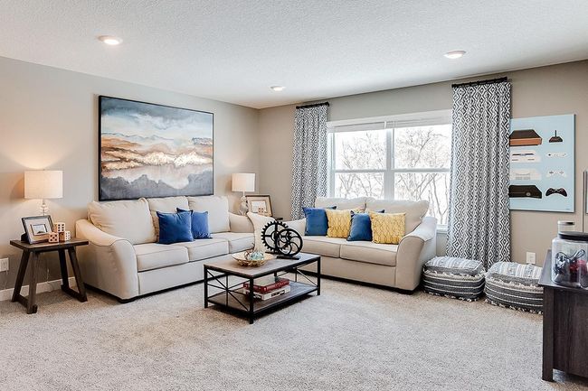 Once upstairs, a focal point offered is this huge loft space. Sure to become a family favorite hangout spot, this room is central located from each of the home's four bedrooms! Photo of model home, color & options may vary. | Image 17