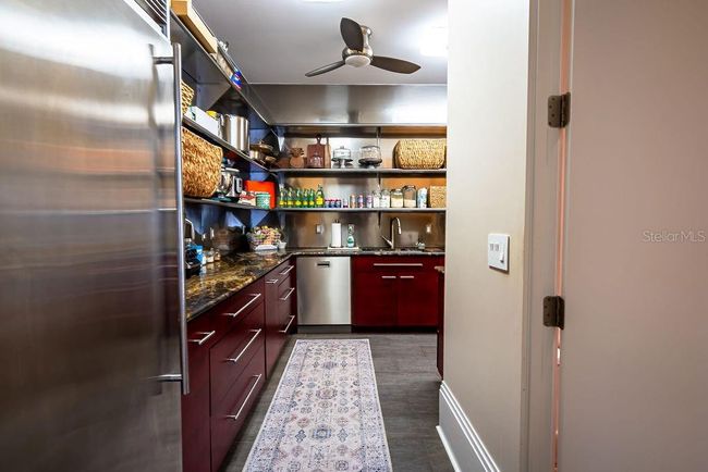 Just behind the open kitchen, the butler's pantry includes a full-size commercial freezer, a second dishwasher, and ample commercial shelving for all your essentials. | Image 25