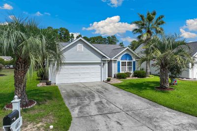 Ranch-style home featuring a garage and a front yard | Image 3