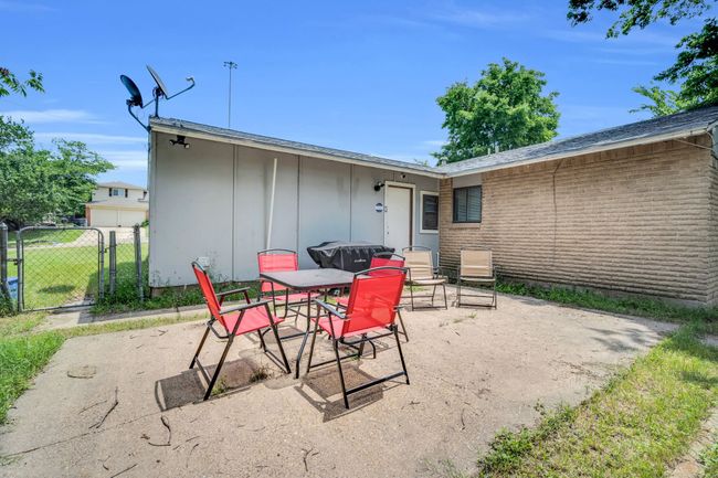 View of patio / terrace featuring a gate, fence, and outdoor dining space | Image 26