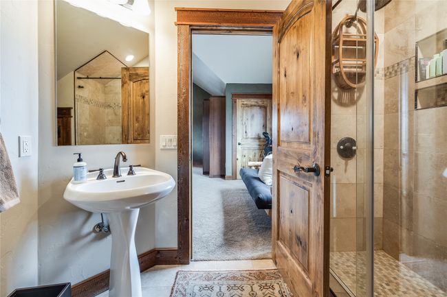 Caretaker Quarters / Guest House. Ensuite bathroom with ensuite bath, a shower stall, baseboards, and tile patterned flooring | Image 86