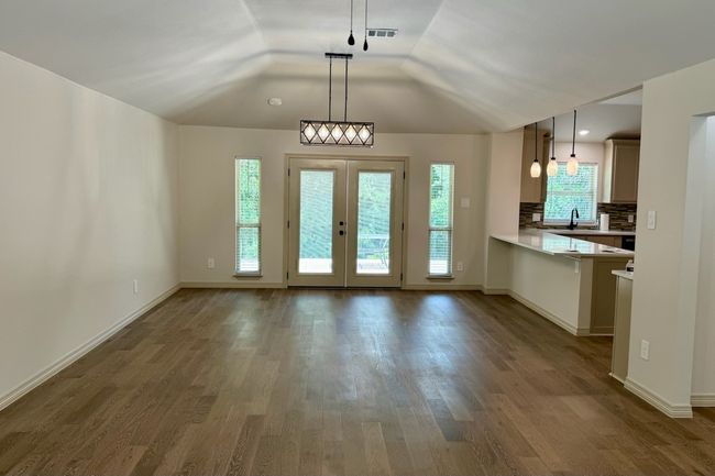 Dining room with double doors and windows overlooking back yard | Image 5