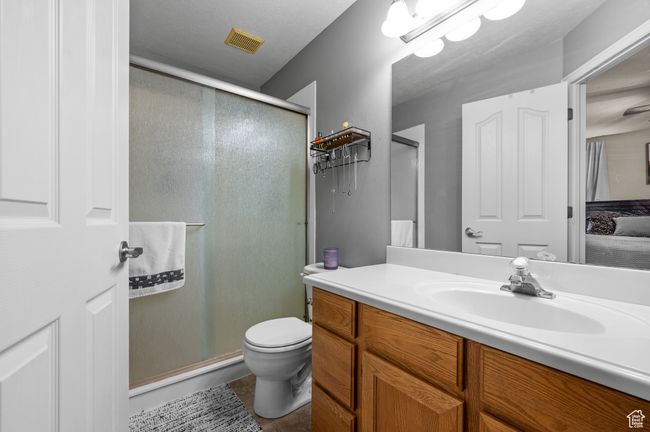 Ensuite bathroom featuring vanity, a shower stall, and tile patterned flooring | Image 19