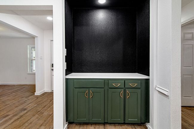 Detailed view of wood finished floors and baseboards | Image 11