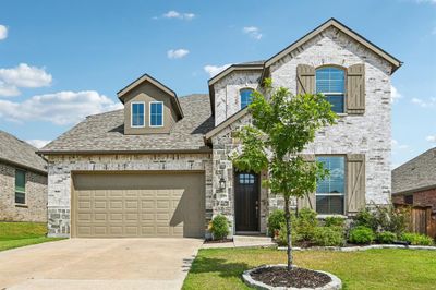 View of front of property featuring a front yard and a garage | Image 1