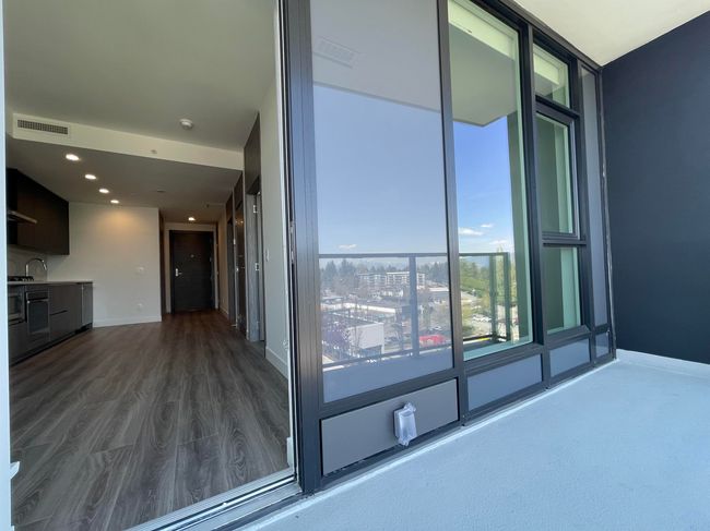 Exterior space featuring dark wood-style flooring, visible vents, recessed lighting, and baseboards | Image 15