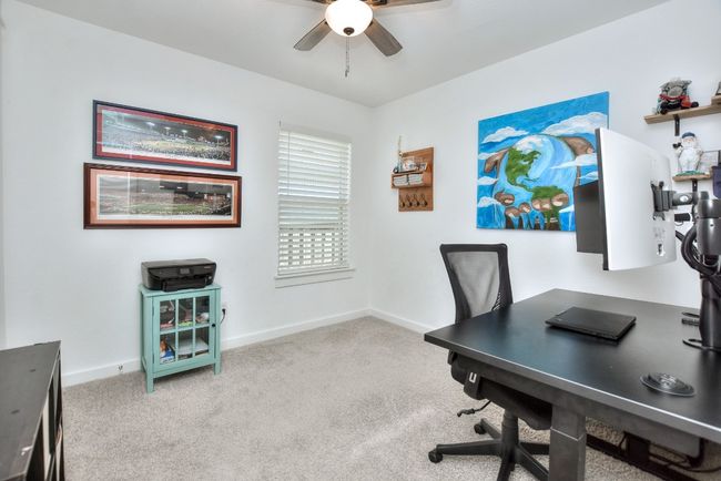 Office featuring baseboards, a ceiling fan, and carpet | Image 19
