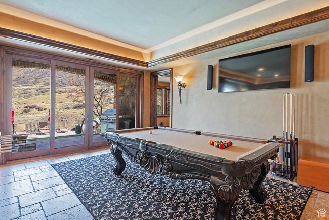 Playroom featuring pool table, stone tile flooring, and a raised ceiling | Image 53