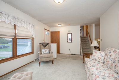 Living room featuring light colored carpet | Image 3