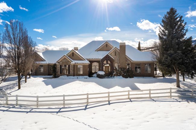 View of front of property featuring a chimney and stone siding | Image 17