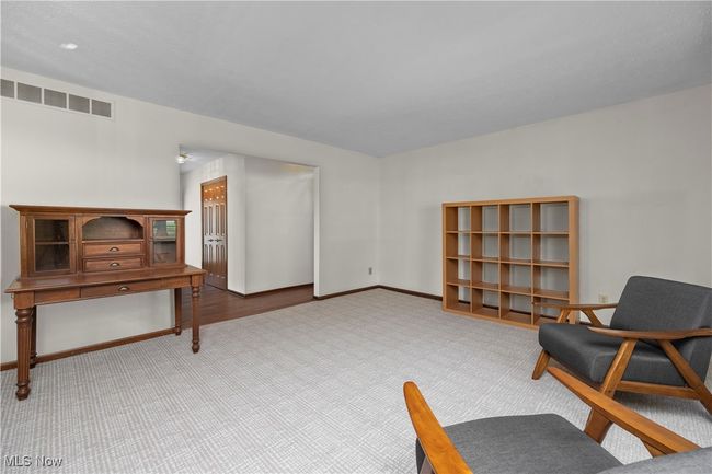 Living area featuring newly carpeted floors | Image 7