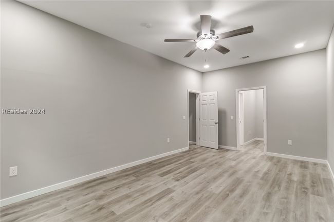 Empty room with ceiling fan and light hardwood / wood-style flooring | Image 29