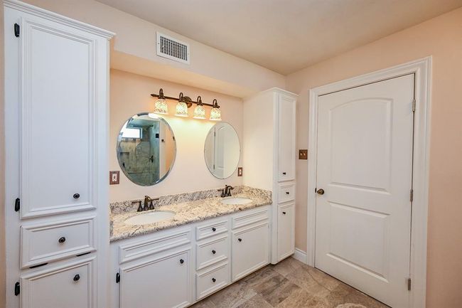 The airiness of the master bathroom sets a happy tone for the day and a sense of relaxation in the evening. Plenty of bathroom storage only adds to the calm of maintaining organization. | Image 19