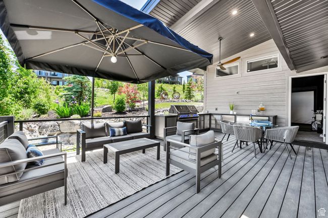 Wooden deck featuring an outdoor hangout area and a grill | Image 62