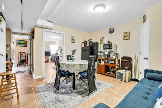 Dining area with light tile patterned floors | Image 20