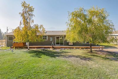 Back of house with a yard and a wooden deck | Image 2