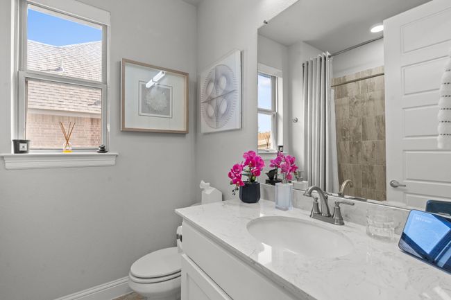 Bathroom with vanity, plenty of natural light, and a shower with shower curtain | Image 22