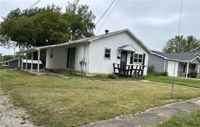 View of front facade with a carport and a front lawn | Image 2