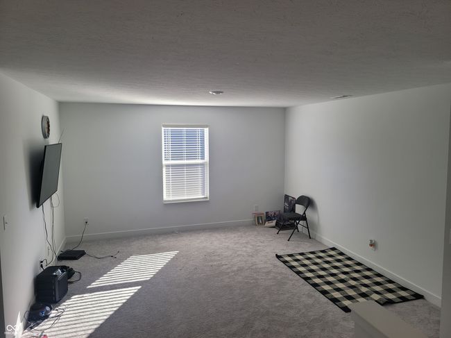 unfurnished room with carpet floors and a textured ceiling | Image 8