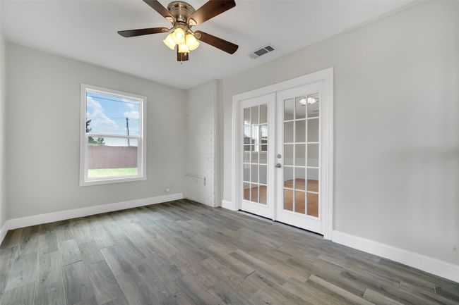 Spare room with french doors, wood finished floors, and ceiling fan | Image 24