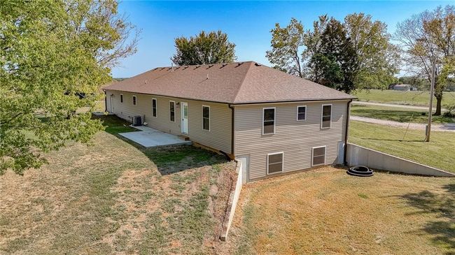 Back of property with cooling unit, a yard, and a patio area | Image 64