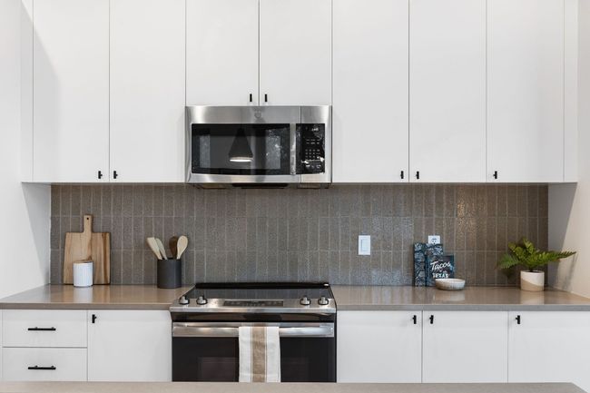 Spacious kitchen with tons of storage, kitchen island that you can eat at, and great light! | Image 31