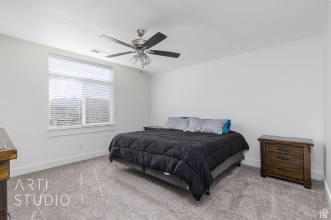 Carpeted bedroom featuring visible vents, baseboards, and ceiling fan | Image 18