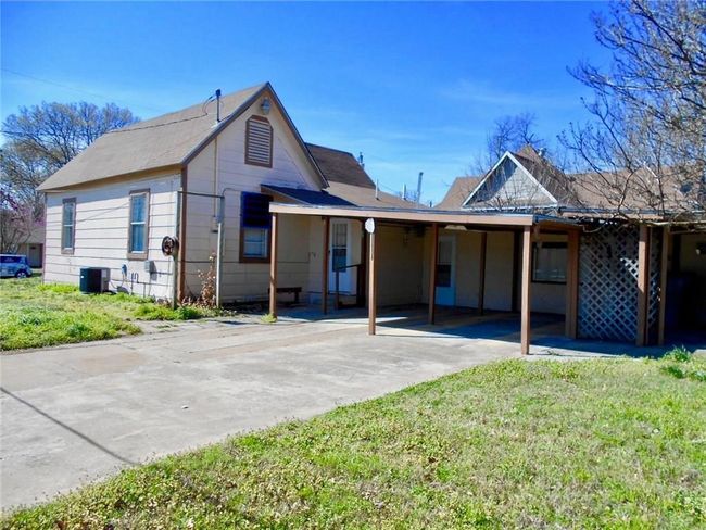 View of front of house with driveway, a carport, and a front yard | Image 17