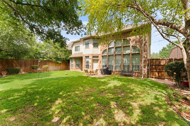 Back of house featuring brick siding, a fenced backyard, and a patio area | Image 37
