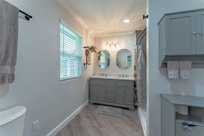 Bathroom with toilet, ornamental molding, wood-type flooring, and vanity | Image 19
