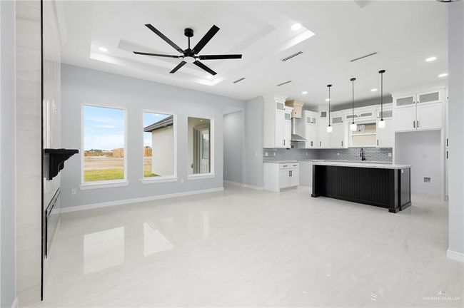 Kitchen with a raised ceiling, baseboards, tasteful backsplash, ceiling fan, and recessed lighting | Image 5