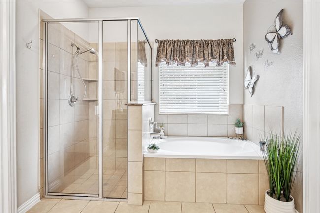 Full bathroom with a shower stall, a bath, and tile patterned floors | Image 17