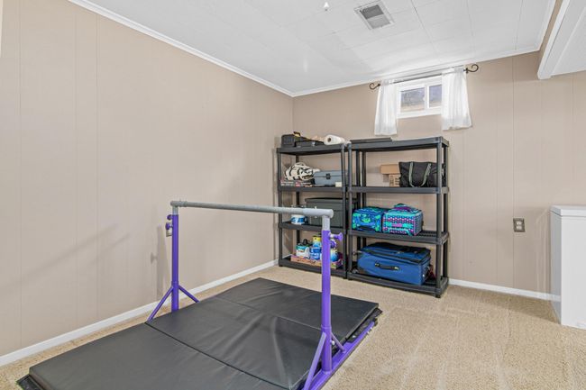 Lower level fifth bedroom. This room is a large space, including this area as well as the area with the additional exercise equipment. Use this space as a bedroom, exercise room, storage, office, and much more! | Image 18