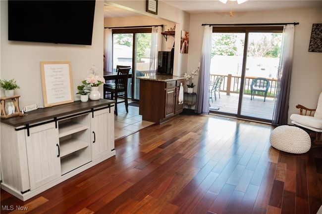 Family room with open shelves, dark wood-type flooring, and white cabinetry | Image 24