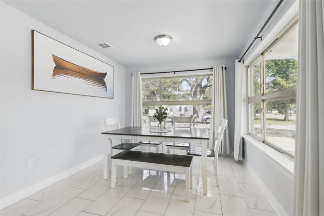 Dining space with light marble finish flooring, plenty of natural light, and baseboards | Image 12