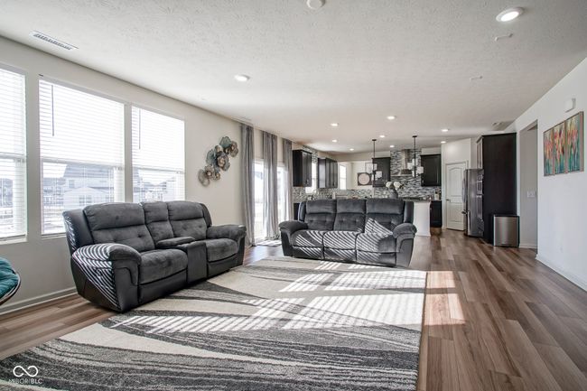living room with recessed lighting, dark wood-style floors, a textured ceiling, and visible vents | Image 16