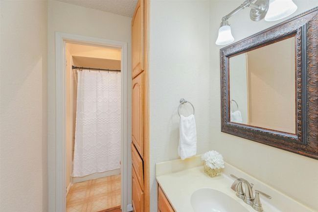 Secondary bathroom with a large cabinet for linens and other bathroom needs. | Image 17